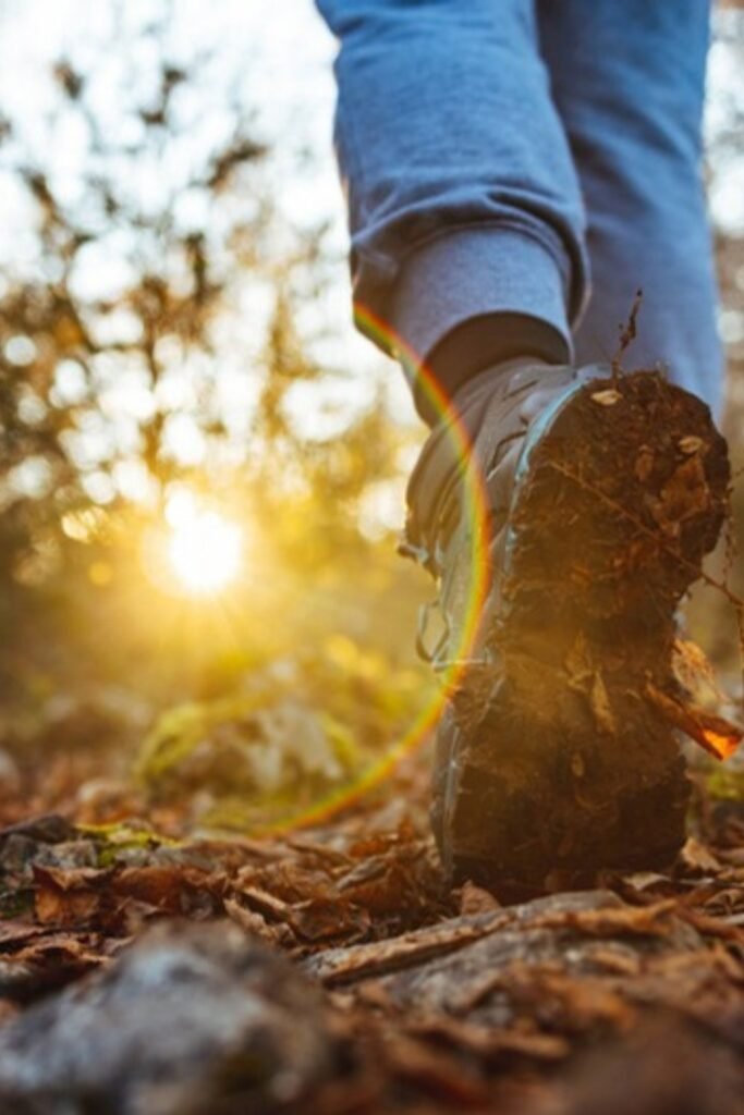 Walking boots on an autumn trail, the simplest way to start weighted vest walking